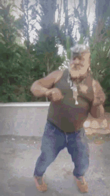 a man with a beard is dancing in a park