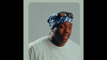 a man wearing a bandana and sunglasses is smiling for the camera