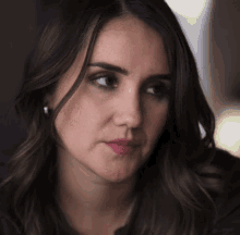 a close up of a woman 's face with a serious expression