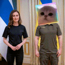 a woman and a man with a cat on their head