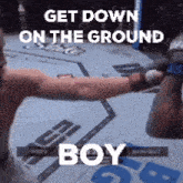 a man in a boxing ring with the words get down on the ground boy above him