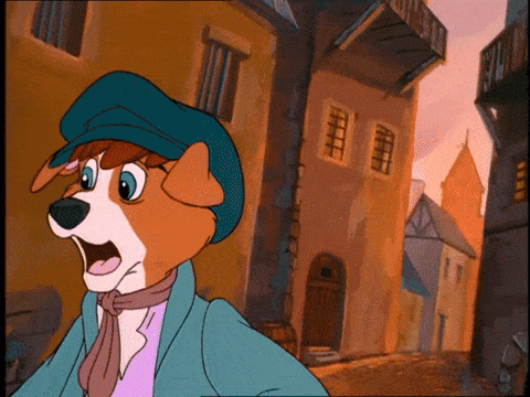 Oliver flees through the streets, pursued by the cats
