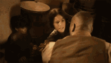 a man and a woman are hugging each other in a room .