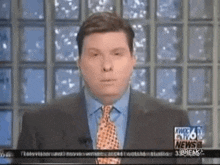 a man in a suit and tie is on the news channel