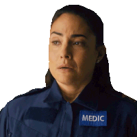 a woman wearing a blue shirt with a patch that says medic on it