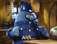 a blue cartoon character says ahh in white letters on his belt