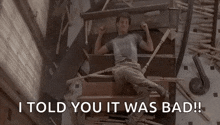 a man is laying on a set of stairs with the words `` i told you it was bad '' .