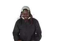 a man with dreadlocks wearing a hat and a jacket