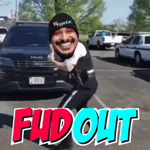 a man standing in front of a police car with the word fud out written on the bottom