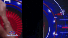 a man in a white suit and black turtleneck is standing in front of a red and blue circle with the words grandefratello on it