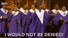 a group of men in purple robes are singing and dancing .