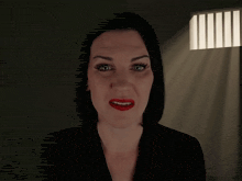 a woman with red nails is pointing her finger up