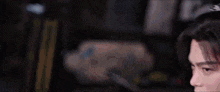 a man and a woman are standing next to each other in a dark room and looking at each other .