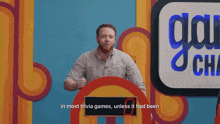 a man stands in front of a sign that says " in most trivia games "