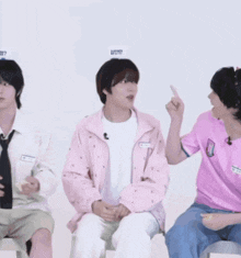 a man in a pink shirt has a name tag that says ' j ' on it