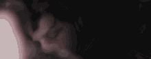 a close up of a person 's face with blood on it and smoke coming out of it .