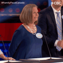 a woman in a blue shirt with a name tag that says sandra on it