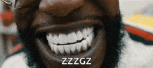 a close up of a man 's mouth with the word zzzgz written on it