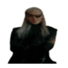 a blurry picture of a man wearing sunglasses and a black suit .