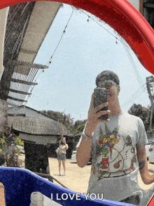 a man taking a picture of himself in a mirror with the words " i love you " on the bottom