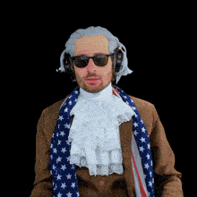 a man wearing a wig and headphones is wearing an american flag scarf around his neck