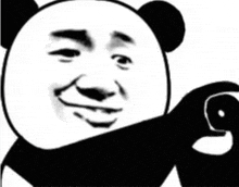 a black and white photo of a panda bear making a funny face and pointing at something .