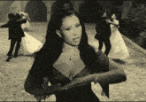 a black and white photo of a woman in a very revealing dress