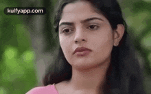 a close up of a woman 's face looking at the camera .