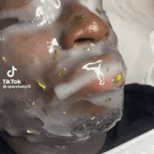 a man with a mask on his face is smoking a cigarette and has the number 13 on his lip