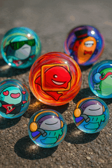 a bunch of colorful marbles with cartoon faces on them