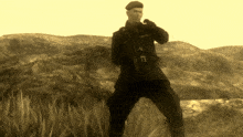 a man in a military uniform stands in a field