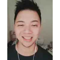 a man wearing ear buds is smiling and looking at the camera