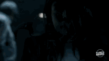 a woman with long hair and a nose ring is looking at a man .