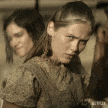 a woman holding a gun with netflix written on the bottom right