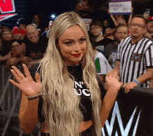 a blonde woman wearing a black shirt that says n' uc