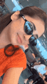 a close up of a woman wearing sunglasses