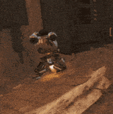 a robot is sitting on a rock with the letter i on the bottom right