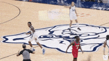 a basketball game is being played on a court with the number 14 on the jersey of one of the players