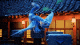 a statue of a blue dragon is sitting on a blue block in front of a building