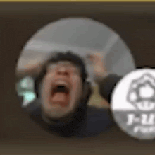 a blurry picture of a man screaming in a circle .