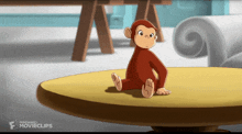 a monkey sitting on top of a table with the word movieclips on the bottom