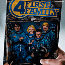 a person is holding a book titled " first 4 family "