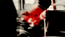 a blurry picture of a person holding a bloody knife