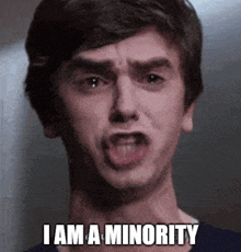 a man is making a funny face with the words i am a minority written below him