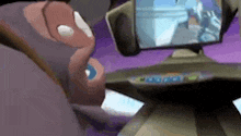 a cartoon character is sitting in front of a computer screen .