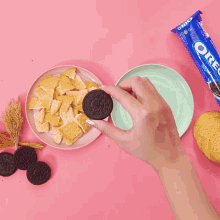 a glass bowl filled with crackers next to a package of oreo cookies