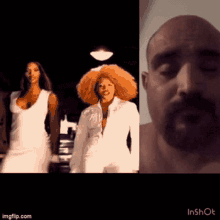 a man with a beard is standing next to two women in white dresses and hats .