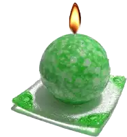 a green ball shaped candle is lit up on a green plate