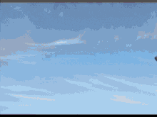 a man in a helmet is flying a plane with a red circle on the tail