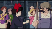 a woman with a red bow on her head talks to a man with a mustache